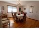 Traditional dining room with hardwood floors, chandelier, and a large window at 12518 N Dixon Dr, Parker, CO 80138