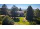 Exterior view of the two-story home nestled between mature evergreens at 12518 N Dixon Dr, Parker, CO 80138