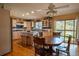 Open kitchen offers a large island, breakfast table, and natural light from the sliding glass doors at 12518 N Dixon Dr, Parker, CO 80138