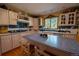 Bright kitchen features a spacious island, wood floors, blue backsplash, and abundant counter space at 12518 N Dixon Dr, Parker, CO 80138