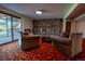 Cozy basement living room with stone fireplace, sliding glass doors, and comfortable seating at 12518 N Dixon Dr, Parker, CO 80138