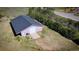 A large outbuilding with a gray roof features a large garage door at 12518 N Dixon Dr, Parker, CO 80138