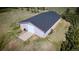 A large outbuilding with a gray roof has a large garage door and a small door at 12518 N Dixon Dr, Parker, CO 80138