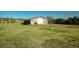 A large outbuilding with a gray roof in a well maintained yard at 12518 N Dixon Dr, Parker, CO 80138