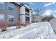 View of building exterior with snowy yard at 7402 S Quail Cir # 1116, Littleton, CO 80127