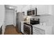 Bright kitchen featuring stainless steel appliances and white cabinets at 7402 S Quail Cir # 1116, Littleton, CO 80127