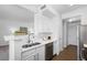 Modern kitchen with stainless steel appliances and white cabinetry at 7402 S Quail Cir # 1116, Littleton, CO 80127