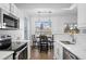 Bright kitchen features white cabinets, stainless steel appliances, and a breakfast nook at 7402 S Quail Cir # 1116, Littleton, CO 80127