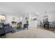 Open-concept living area features plush carpet, modern decor, and natural light at 7402 S Quail Cir # 1116, Littleton, CO 80127