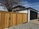 Side view of a garage with a black door and natural wood privacy fence at 2000 Irving St, Denver, CO 80211