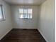 Neutral bedroom featuring wood floors and natural light at 2000 Irving St, Denver, CO 80211