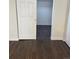 Bedroom with wood flooring, walk-in closet, and freshly painted white walls at 2000 Irving St, Denver, CO 80211