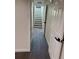 Hallway featuring modern doors and dark wood flooring leading to the stairs at 2000 Irving St, Denver, CO 80211