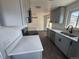 Modern kitchen featuring gray cabinets, quartz countertops, stainless steel appliances, and wood-look flooring at 2000 Irving St, Denver, CO 80211