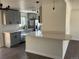 Renovated kitchen with quartz countertops, gray cabinets, stainless steel appliances, and an eat-in peninsula at 2000 Irving St, Denver, CO 80211