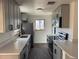 This remodeled kitchen offers white countertops, stainless steel appliances and stylish grey cabinetry at 2000 Irving St, Denver, CO 80211
