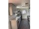 Stylish kitchen featuring stainless steel appliances, sleek countertops, and dark wood flooring at 2000 Irving St, Denver, CO 80211