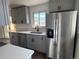 Stylish kitchen showcases gray cabinets, quartz countertops, stainless steel appliances, and a modern refrigerator at 2000 Irving St, Denver, CO 80211