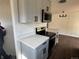 Well-equipped kitchen featuring quartz countertops, stainless steel appliances, and gray cabinets at 2000 Irving St, Denver, CO 80211
