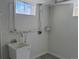Bright laundry room with a utility sink, white walls, and natural light from a window at 2000 Irving St, Denver, CO 80211