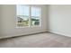 Bright bedroom featuring plush carpet and large windows offering scenic neighborhood views at 4978 Hickory Oaks St, Castle Rock, CO 80104