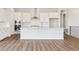 Open kitchen with white cabinets, stainless steel appliances, and an island with counter seating at 4978 Hickory Oaks St, Castle Rock, CO 80104