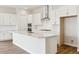 Modern kitchen with white cabinets, stainless steel appliances, and a large center island at 4978 Hickory Oaks St, Castle Rock, CO 80104