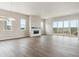 Expansive living room with a fireplace, bright windows, and sliding door to outside deck at 4978 Hickory Oaks St, Castle Rock, CO 80104