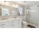 Bright bathroom featuring a large glass shower, double sinks, and stylish white cabinetry at 3178 Geneva Ct, Denver, CO 80238