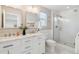 Bathroom with double vanity, framed mirrors, glass shower door and hexagon tile flooring at 3178 Geneva Ct, Denver, CO 80238