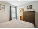 Bright bedroom featuring a window with blinds, dresser, and neutral decor at 3178 Geneva Ct, Denver, CO 80238
