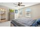 Comfortable bedroom features large windows, a ceiling fan and a dresser with a TV at 3178 Geneva Ct, Denver, CO 80238