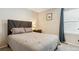 Cozy bedroom features neutral tones, plush bedding, and a bedside table with a lamp for a relaxing ambiance at 3178 Geneva Ct, Denver, CO 80238