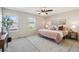 Bright bedroom features two windows, neutral walls, ceiling fan and light gray carpet at 3178 Geneva Ct, Denver, CO 80238