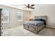 Bedroom featuring a stylish gray bed frame, plush carpet, and windows that provide plenty of natural light at 3178 Geneva Ct, Denver, CO 80238