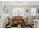 Dining room featuring wooden table and chairs set, modern chandelier, and geometric rug with view to living area at 3178 Geneva Ct, Denver, CO 80238
