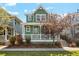Charming two-story home with a welcoming front porch, green siding, and landscaped front yard at 3178 Geneva Ct, Denver, CO 80238