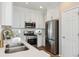 Modern kitchen with stainless steel appliances, quartz countertops, and bright lighting at 3178 Geneva Ct, Denver, CO 80238