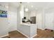 Modern white kitchen featuring stainless steel appliances, white marble countertops, and trendy globe pendant lighting at 3178 Geneva Ct, Denver, CO 80238