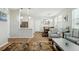 Bright and airy living room with hardwood floors, neutral walls, and stylish furnishings and kitchen view at 3178 Geneva Ct, Denver, CO 80238
