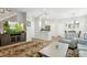 Open-concept layout connecting the living room with a TV, kitchen and dining area, perfect for entertaining at 3178 Geneva Ct, Denver, CO 80238