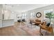 Open-concept living area featuring a dining table, lots of seating and natural light at 3178 Geneva Ct, Denver, CO 80238