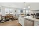 Open living space combining kitchen, dining area, and living room, with modern finishes and natural light at 3178 Geneva Ct, Denver, CO 80238