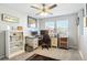 Bright office space featuring a ceiling fan, two large windows, and dual desks offering a productive environment at 3178 Geneva Ct, Denver, CO 80238