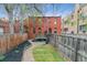 Charming backyard with a wooden deck, fence, mulched flower bed, and a flagstone path leading to green grass at 39 S Grant St, Denver, CO 80209