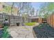 Spacious backyard with stone path, grass, privacy fence, garden bed, and potted plants at 39 S Grant St, Denver, CO 80209