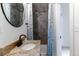 Bathroom featuring granite counters, modern fixtures, and tiled shower at 39 S Grant St, Denver, CO 80209