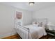 Cozy bedroom with a white metal bed frame and hardwood floors at 39 S Grant St, Denver, CO 80209