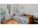 Bright bedroom featuring hardwood floors, a daybed, and a decorative window at 39 S Grant St, Denver, CO 80209