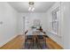 Well-lit dining area with glass table, hardwood floors, and vintage chandelier at 39 S Grant St, Denver, CO 80209